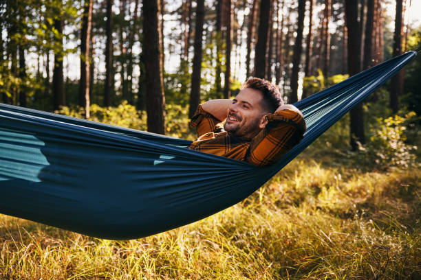istock Relaxed man smiling in a hammock in forest 2172008867