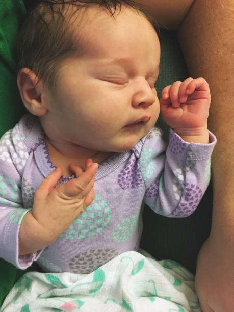 Newborn girl in the hospital on the day of her birth