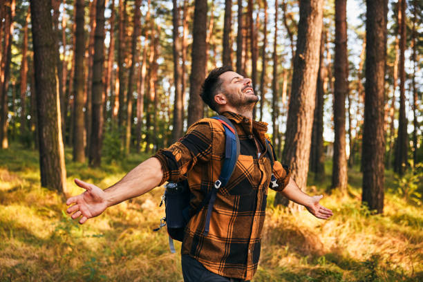 istock Happy man embraces forest nature during autumn hike 2172008940