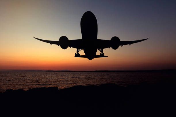 istock Silhouette of an airplane just after take-off during sunset 2172009402