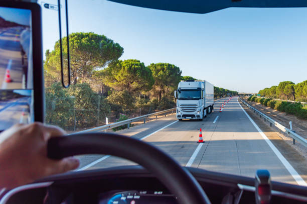 istock View from inside a truck on a highway with cones separating the two lanes for two-way traffic, transfer. 2172010688