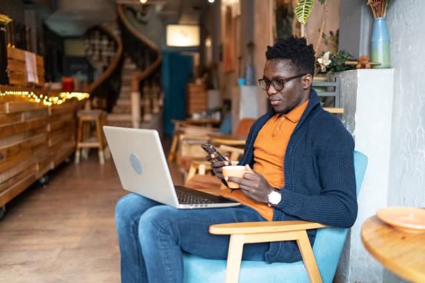 istock Handsome male student using his laptop in a coffee shop 2172015943