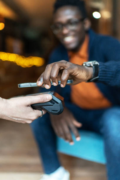 istock Young man mobile paying in a coffee shop 2172016991