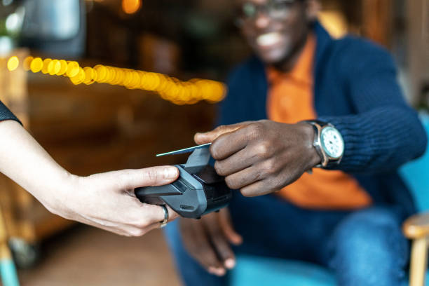 istock Young man handing credit card at a cafe 2172017125