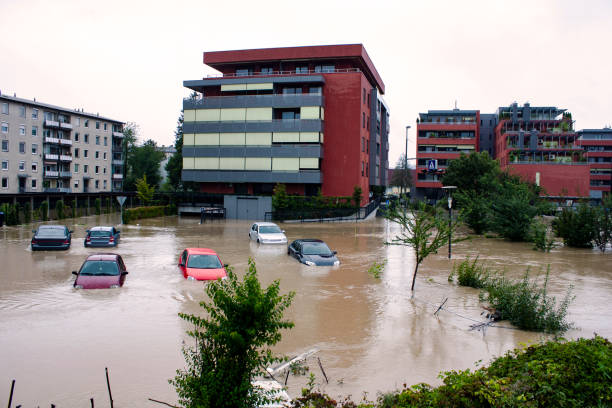 Cars under the water on the flood water in the city street