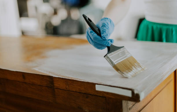 istock A young girl paints an old wardrobe. 2172019501