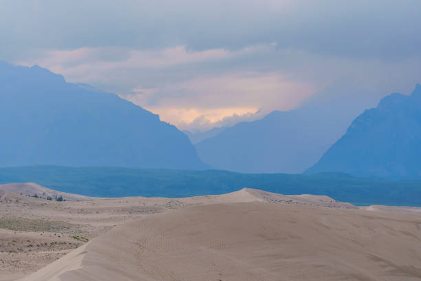 istock Dramatic desert dunes under sunbeams and cloudy sky 2172025216
