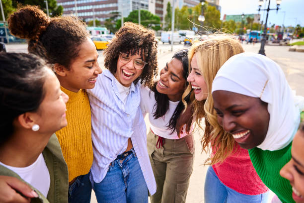 istock Group of multicultural young only women standing hugging in circle laughing having fun outdoors. 2172025402
