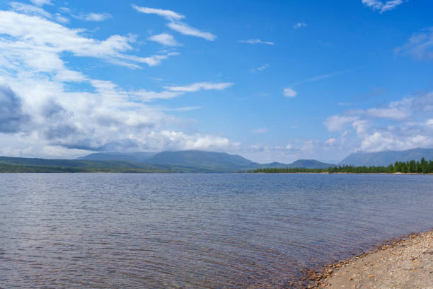 istock Scenic lake with mountain backdrop under blue sky 2172026336