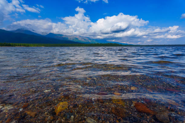 istock Clear lake with mountain views under a partly cloudy sky 2172030778