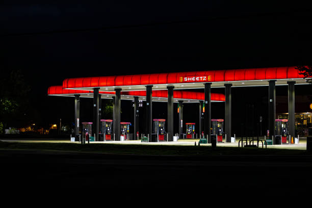 Boulder, Colorado, USA - October 9, 2025: Car pulling up to a Shell gas station pump under the illuminated canopy at night