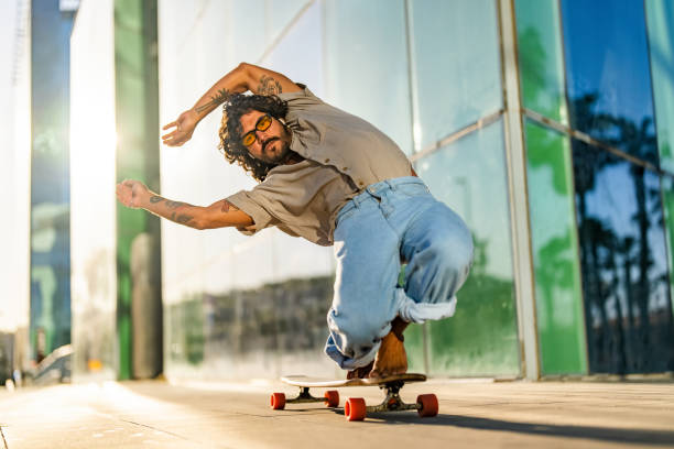 istock Hispanic Male Performing Longboard Stunt in Urban Setting 2172032976