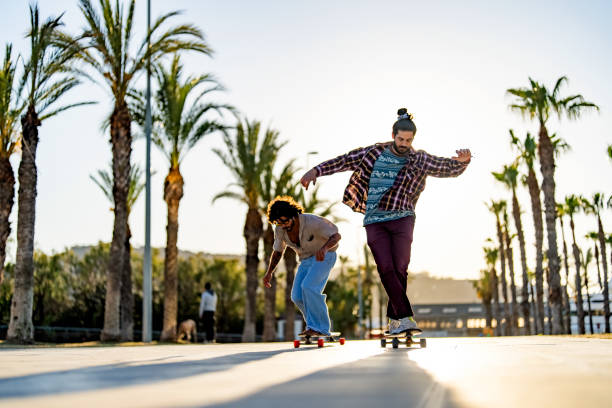 istock Diverse Male Friends Enjoy Longboard Ride 2172032996