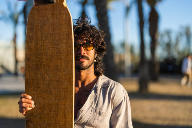 istock Hispanic Man with Longboard Outdoors 2172033006