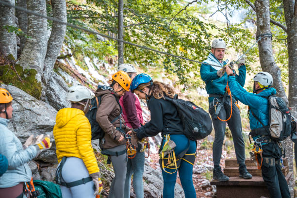 istock Diverse Group of Adventurers Receiving Zip Line Instruction in Forest Setting 2172033333