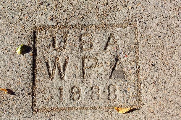 istock Closeup of a 1938 stamp in concrete for the WPA program . 2172039166