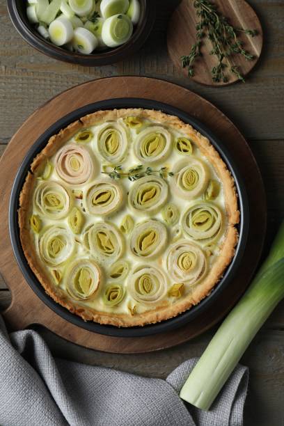 istock Tasty leek pie fresh stalk and thyme on wooden table 2172040791