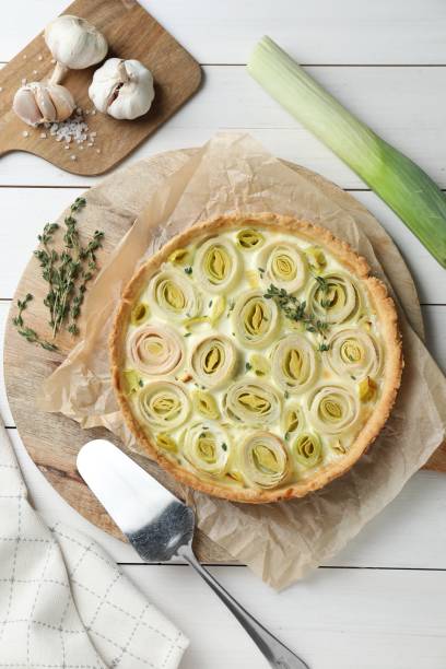 istock Flat lay composition with tasty leek pie and products on white wooden table 2172040814