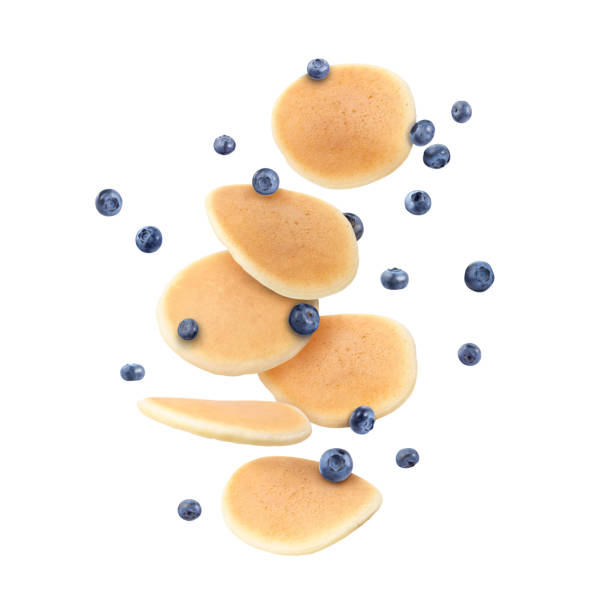 istock Many fresh pancakes and blueberries flying on white background 2172041143