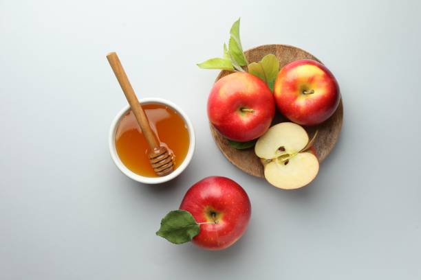 istock Sweet honey and fresh apples on white table, flat lay 2172041199