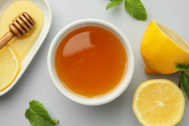 istock Sweet honey and fresh lemon on white table, flat lay 2172041280