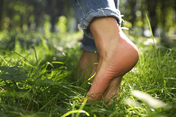 istock Woman walking barefoot on green grass outdoors, closeup 2172042994