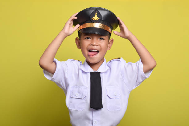 istock Asian boy Beaming airplane pilot holding hat in arms 2172044492