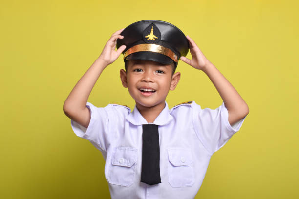 istock Asian boy Beaming airplane pilot holding hat in arms 2172044493