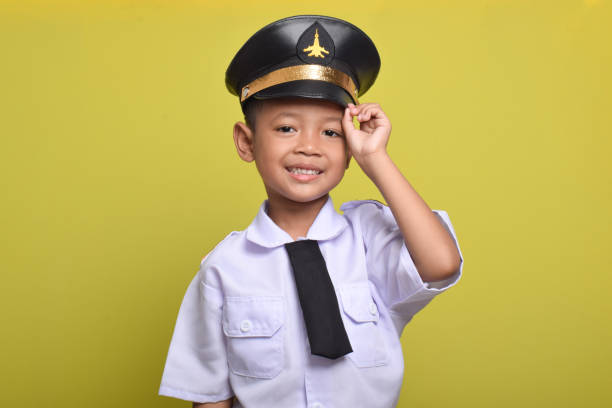 istock Asian boy Beaming airplane pilot holding hat in arms 2172044521