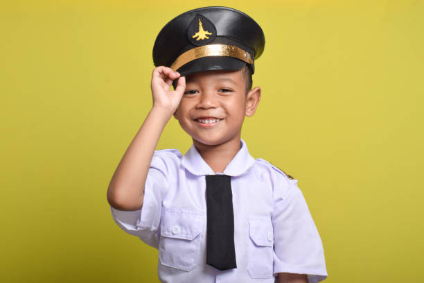 istock Asian boy Beaming airplane pilot holding hat in arms 2172044531