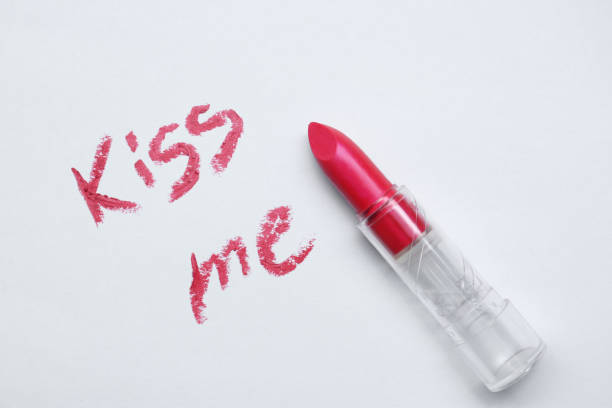 istock Red lipstick and phrase Kiss Me written on white background, top view 2172047736