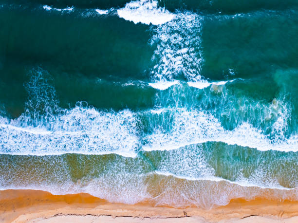 istock Top view waves crashing on sandy shore, Beach sea space nature background 2172048022
