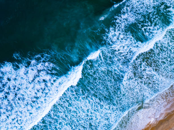 istock Top view waves crashing on sandy shore, Beach sea space nature background 2172048028