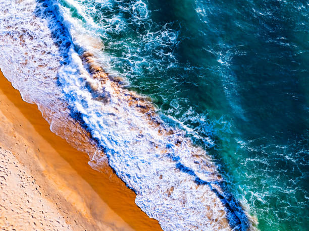 istock Top view waves crashing on sandy shore, Beach sea space nature background 2172048036