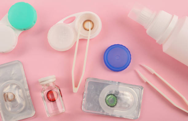istock Flat lay composition with color contact lenses on pink background 2172048654