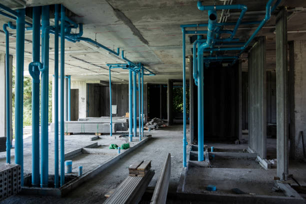 istock A large building currently under construction that has many blue pipes 2172055778