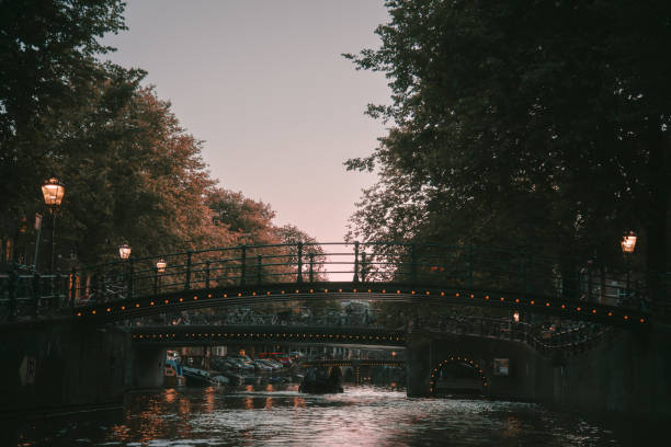 Canal View with Illuminated Bridges at Twilight - Amsterdam, Netherlands