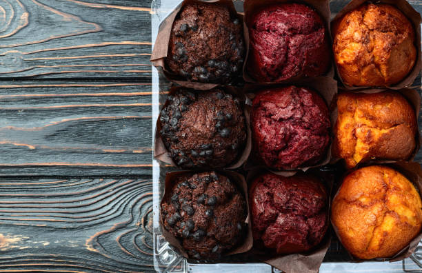 istock Mix of muffins ( cupcake ) chocolate , vanilla , berries . Top view 2172067677