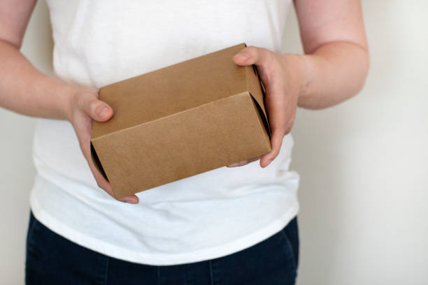 istock Man holding in hand small cardboard paper box. 2172067770