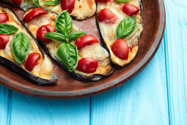 istock Italian mini pizza . Aubergine (eggplant ) with mozzarella cheese and basil . On rustic background 2172067925