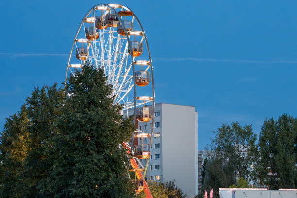 A large Ferris wheel is lit up at night