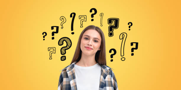 istock Woman with question marks on yellow background. 2172071584