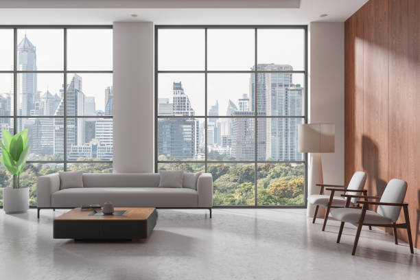 istock Wooden home living room interior with sofa and armchairs, panoramic window 2172072234