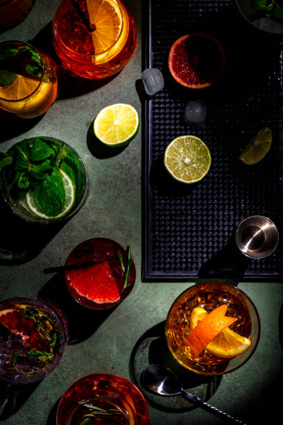 istock Alcoholic cocktails and bar tools on green background, top view 2172073486