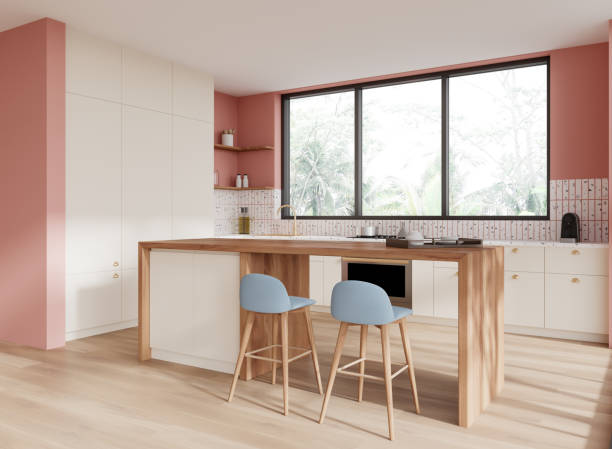 istock Colored home kitchen interior with island and cooking cabinet, panoramic window 2172073505