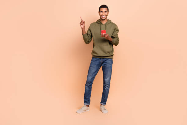 istock Photo of successful man freelancer hand presenting empty space offer discounts quality modern device isolated on beige color background 2172078572