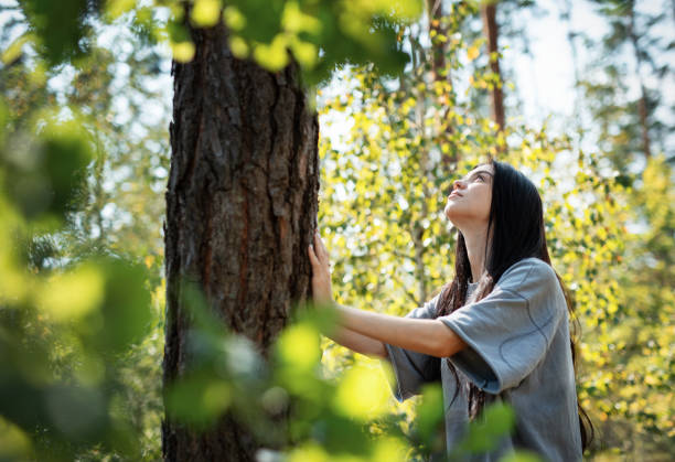 istock A young girl hugs a tree in the forest. 2172088274