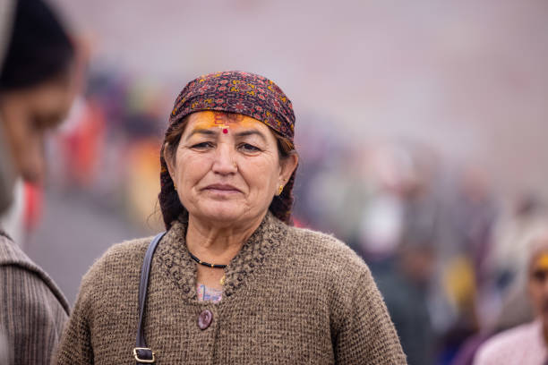 Varanasi, Uttar Pradesh, India - January 2024: Portrait of the hindu woman in traditional clothes walking on the streets of varanasi post taken the darshan of lord shiv in kashi vishwanath temple.