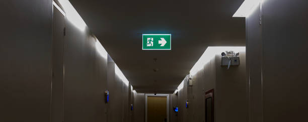 istock Green emergency exit sign showing the way to escape. 2172090441