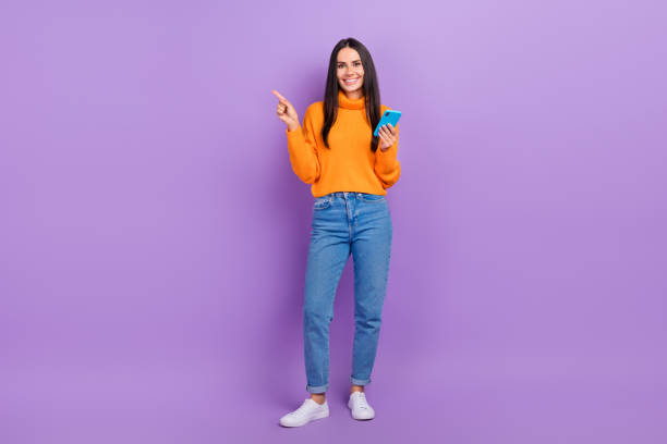 istock Full body photo of blogger lady hold gadget point empty space doing web purchase isolated purple color background 2172095517